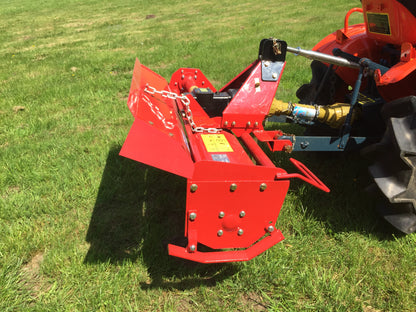 FarmMaster tractor rotavator attachment on a tractor in a grassy field