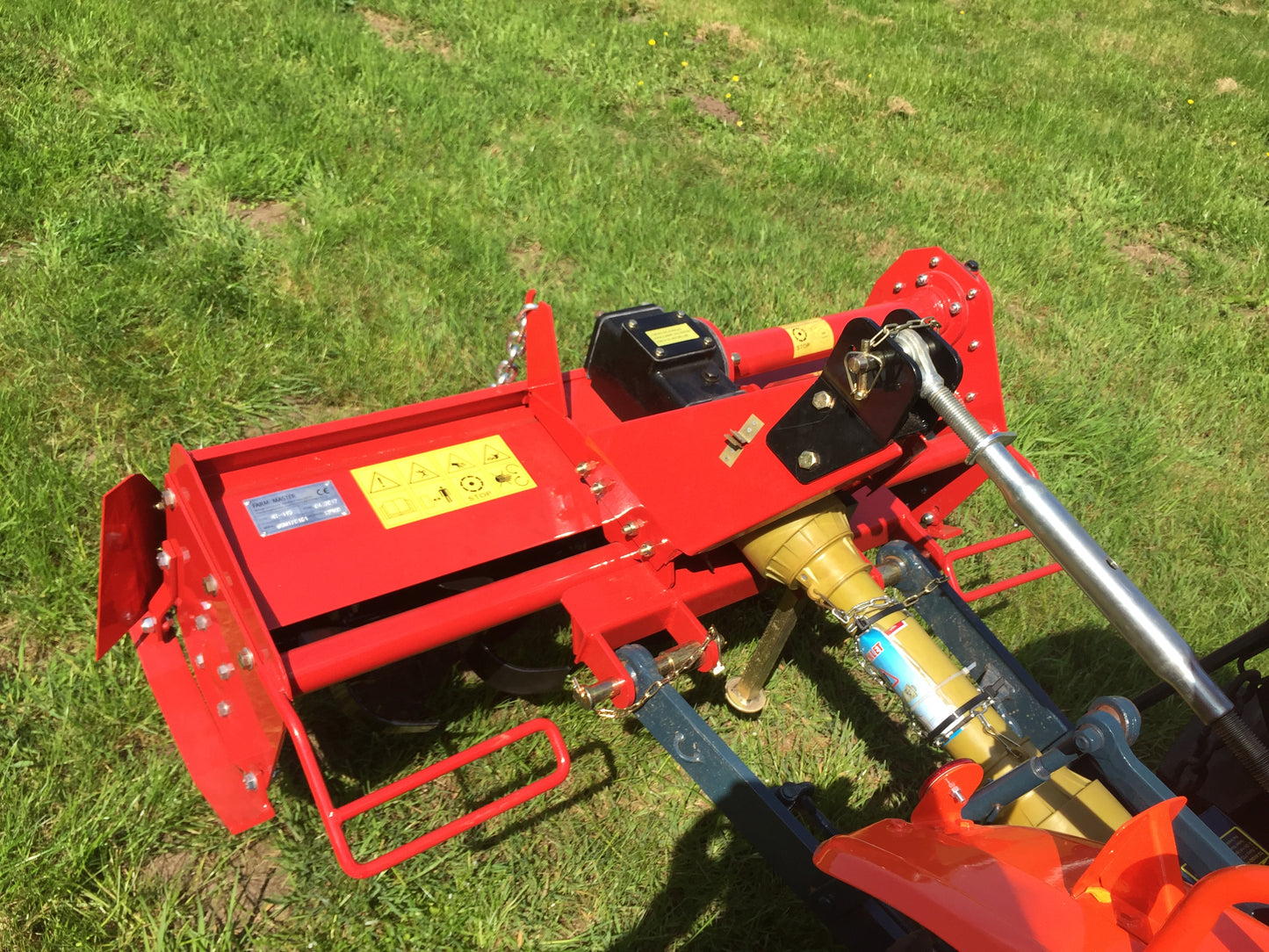 FarmMaster tractor tiller on a grassy field