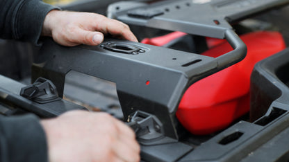 Person working on a Can-Am ATV