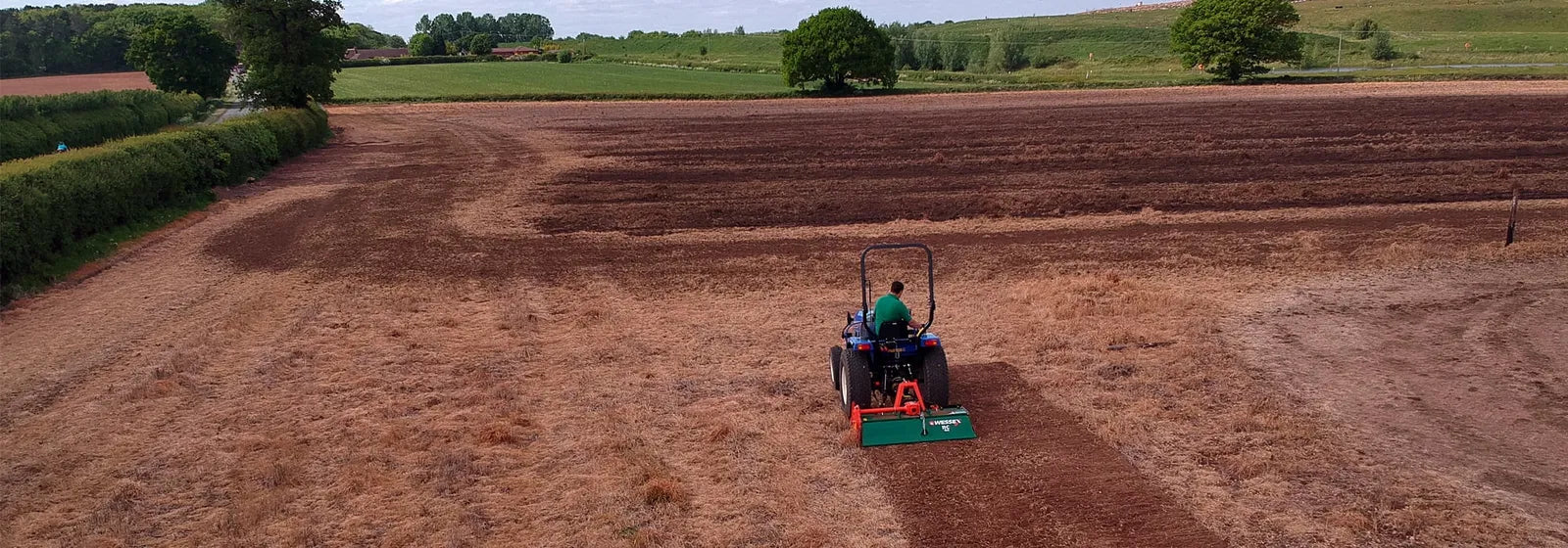 Wessex tractor rotavator with a rural landscape in the background