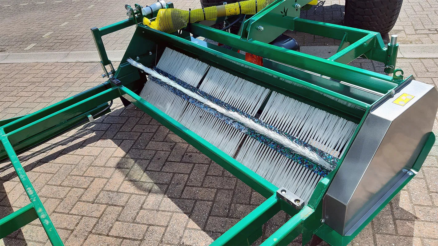 Green Wessex flail collector with a metal screen on a paved surface