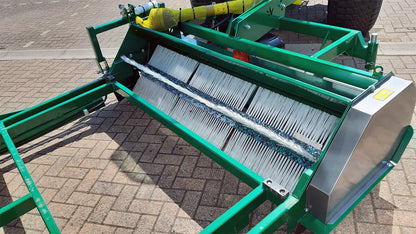 Green Wessex flail collector with a metal screen on a paved surface