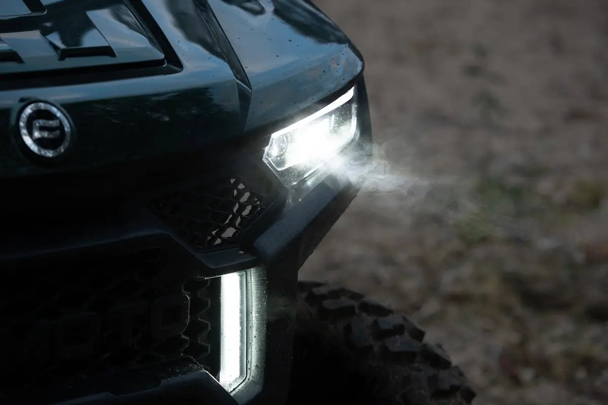 Close-up of a CFMOTO U10 Pro UTV headlight with a blurred background