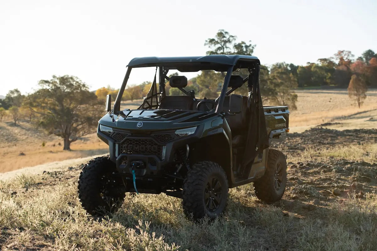 CFMOTO U10 Pro Off-road vehicle on a dirt road with trees and open sky in the background
