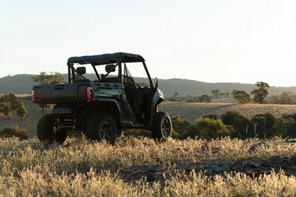 CFMOTO U10 Pro UTV in a field with trees and mountains in the background