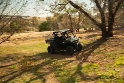 CFMOTO U10 Pro UTV on a dirt path in a natural landscape with trees and open fields.