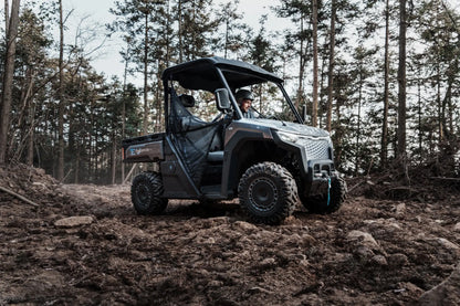 CFMOTO U6EV Electric UTV Utility vehicle driving through a forested area