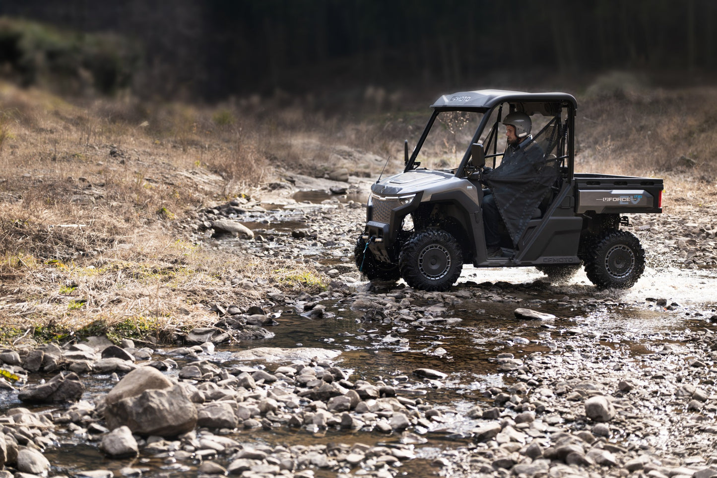 CFMOTO U6EV Electric UTV crossing a stream in a natural setting