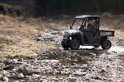 CFMOTO U6EV Electric UTV crossing a stream in a natural setting