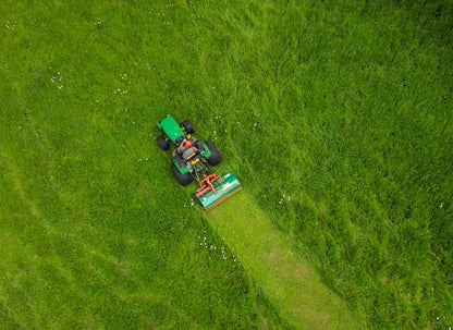 Person mowing a lawn from an aerial perspective