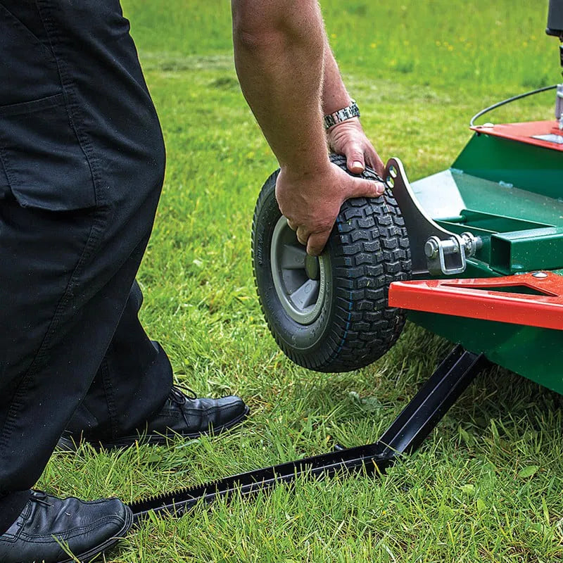 Person adjusting a wheel on a Wessex ATV topper mower