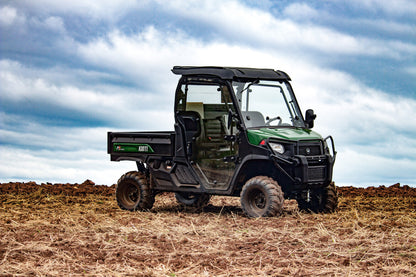 Kioti K9 utility vehicle in a field with a cloudy sky