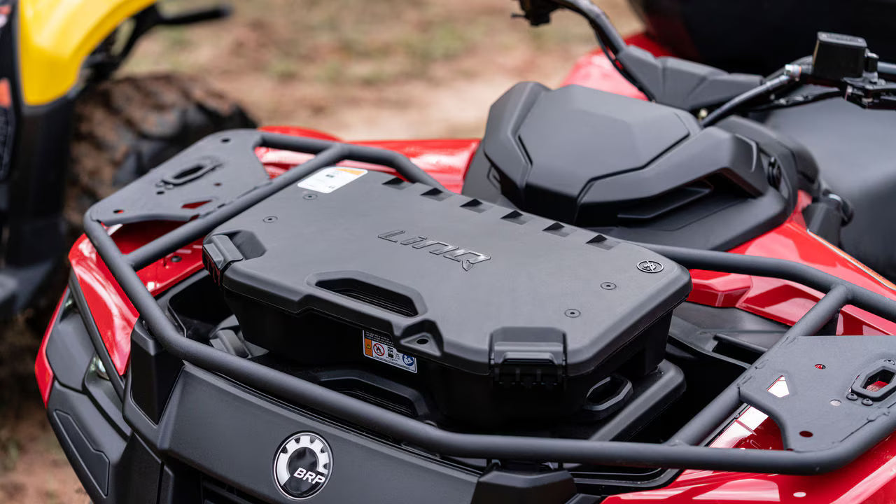 Close-up of a red Can-Am ATV with a black storage box