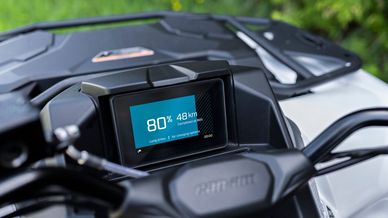 Close-up of a Can-Am ATV dashboard with digital display showing speed and distance.