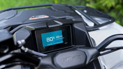 Close-up of a Can-Am ATV dashboard with digital display showing speed and distance.