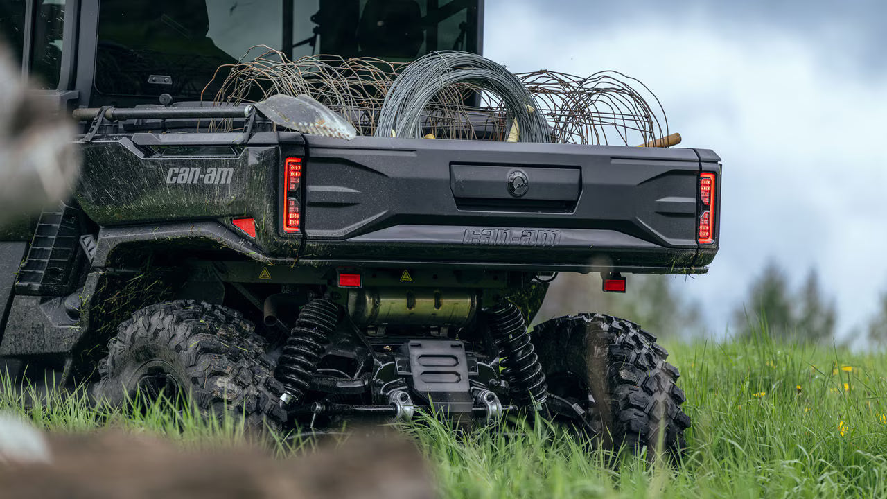 Black UTV with 'Can-Am' branding in a grassy field.