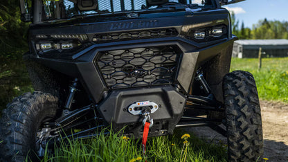 Black Can-Am UTV with visible branding in a grassy outdoor setting