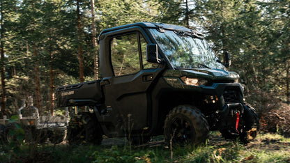 Green Can-Am utility vehicle in a forest setting