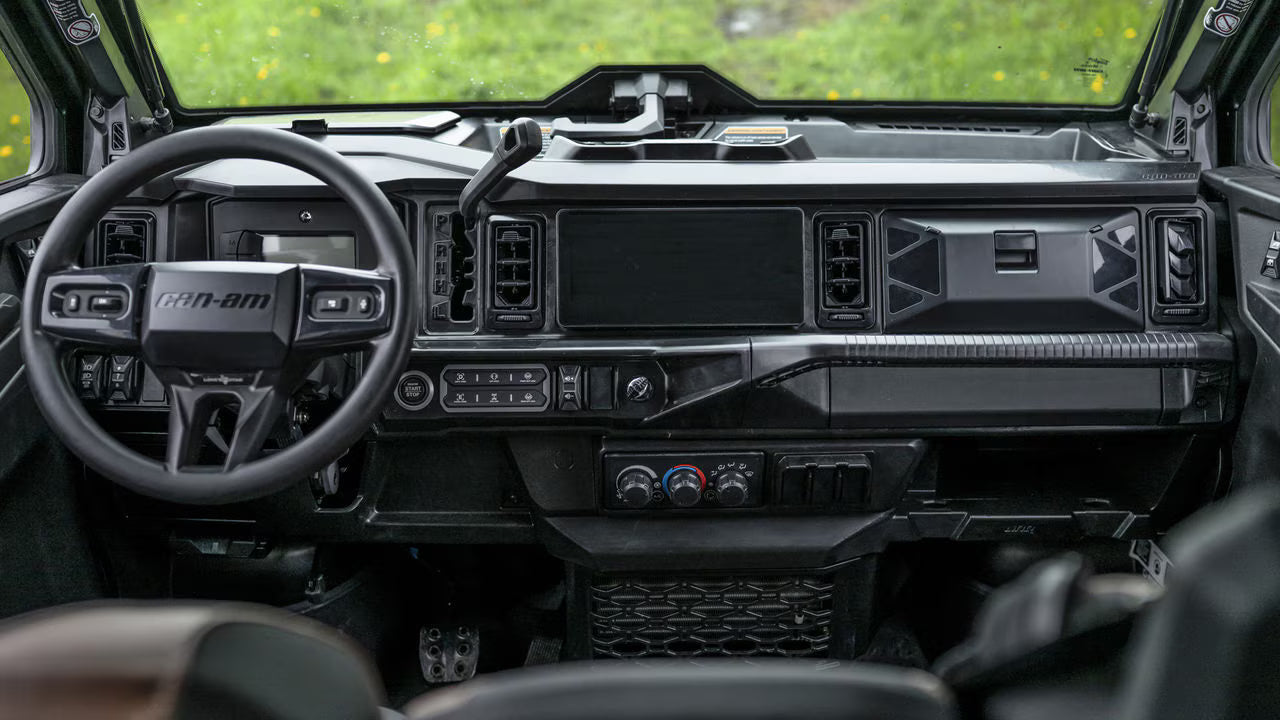 Interior of a high-tech Can-Am Traxter with a steering wheel and dashboard.
